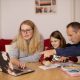 fun way to teach your kids about money ukds blog parents sat around laptop with child