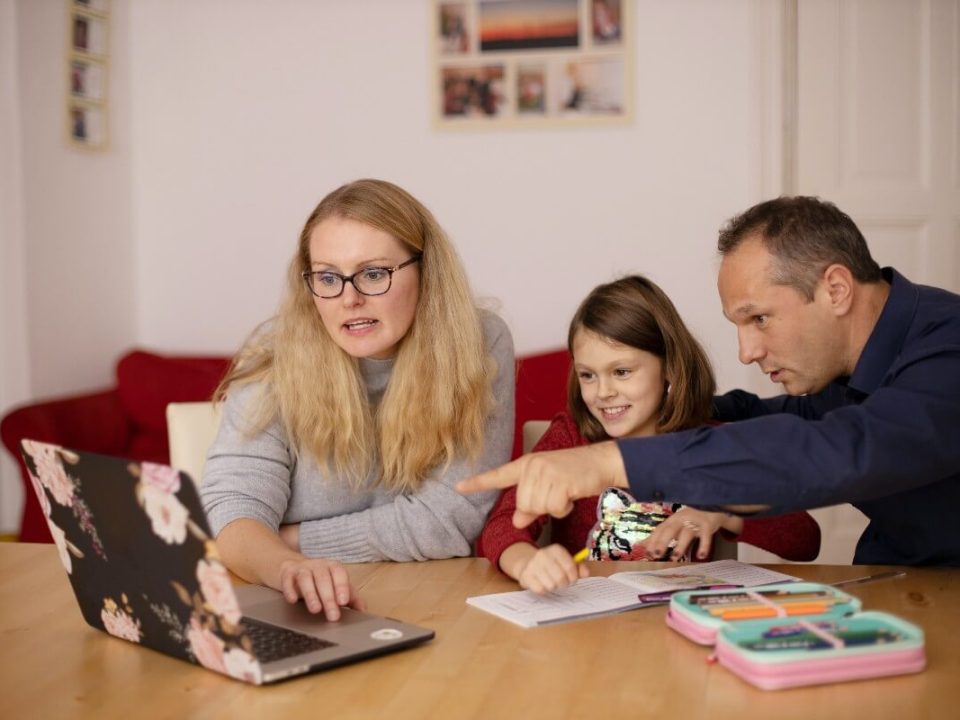 fun way to teach your kids about money ukds blog parents sat around laptop with child